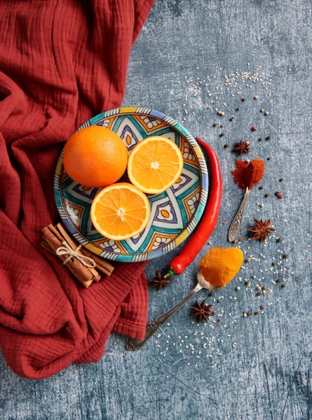 Koyu gri arkaplandaki sulu portakallar ve baharatlar fotokopi alanı içeriyor. Zerdeçal, paprika tozu, kırmızı biber ve taze meyve renkleri. Sağlıklı yeme kavramı. 