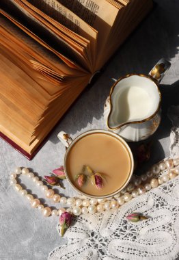 Sütlü ve güllü bir fincan çay. Güzel bir bardakta çay. Sıcak aromatik içeceğin fotoğrafını kapat.. 