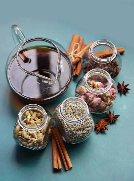 Farklı çay çeşnileri üst görünüm fotoğrafı. Tarçın, anason, kakule, karanfil, lavanta, masada güller. Aromatik çay yakın çekim. Doğal antioksidan kavramı. 