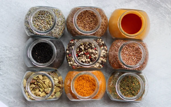 Close Photo Various Spices Glass Jars Cardamom Flax Seeds Mixed — Stockfoto