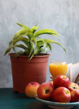 Bir bardak portakal suyu ve taze şeftali ile dolu bir hayat. Yaz meyvesi yakın çekim fotoğrafı. Kopyalama alanı olan açık gri arkaplan. 