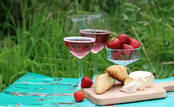 Refreshing summer cocktails on a garden table. Close up photo of glasses with various drinks. Party in a garden.