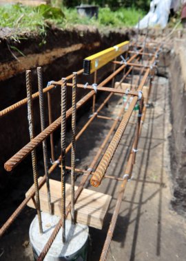 Reinforcement steel bars close up photo. Strengthening of foundation in building. Construction work in process. 