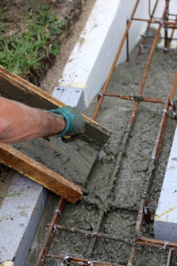 Foundation strength works in process. Reinforcement steel bars, concrete mixer, cement close up photo. Home renovation concept.  
