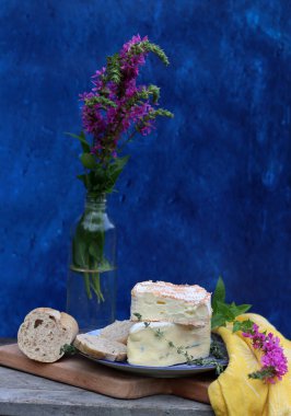Still life with French cheese. Soft cheese close up photo. French appetizer on a plate. 