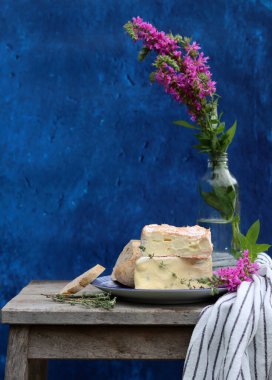 Still life with French cheese. Soft cheese close up photo. French appetizer on a plate. 