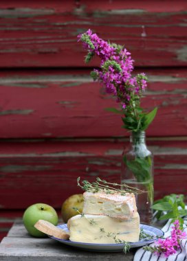 Still life with French cheese. Soft cheese close up photo. French appetizer on a plate. 