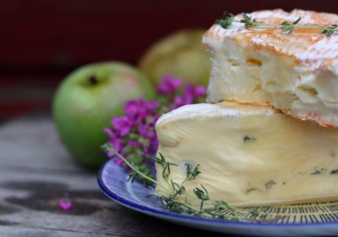 Close up photo of mild cheese. Delicious French cheese on a plate. 