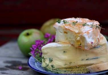 Close up photo of mild cheese. Delicious French cheese on a plate. 
