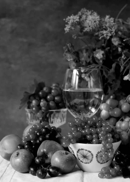 Black and white photo still life with glass of wine and summer berries.