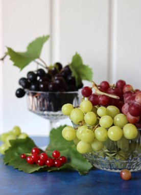 Black, green and red grapes on close up.  Top view photo of seasonal fruits. Healthy eating concept. 