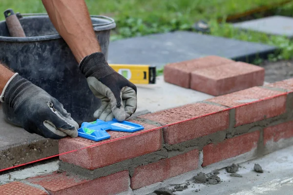 Male Hands Protective Gloves Holding Red Bricks Construction Worker Builds — 图库照片