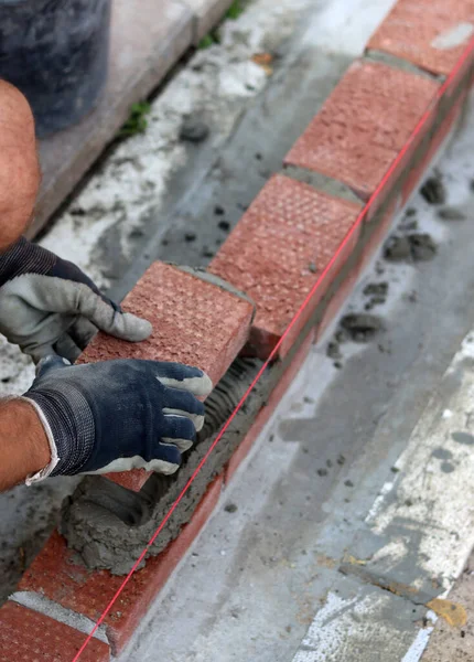 Male Hands Protective Gloves Holding Red Bricks Construction Worker Builds — Stok Foto