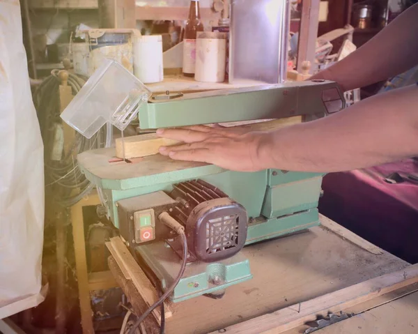 Green band saw, carpenter in an old Asian factory.green electric jigsaw