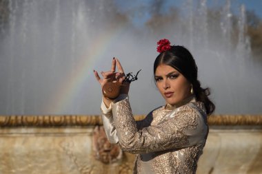 Genç flamenko kadın portresi, İspanyol ve esmer, tipik flamenko dans takımı, boğa güreşçisi ceketi ve kastanet çalan. Flamenko kavramı, dansçı, tipik İspanyol dansı..