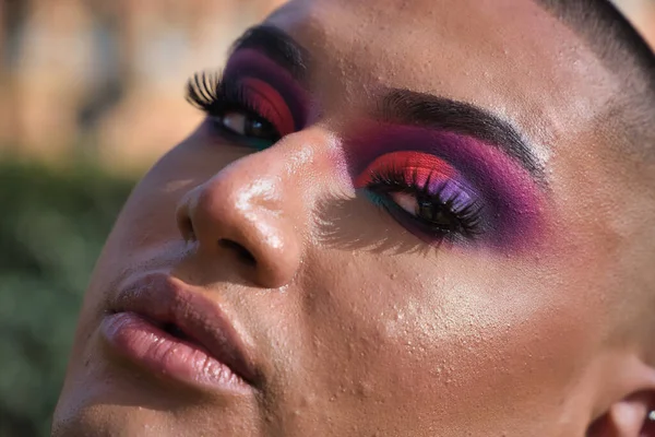 Detail of eyes of non-binary, young, South American person, heavily make up, close up. Concept queen, lgbtq+, pride, queer, eye shadow.