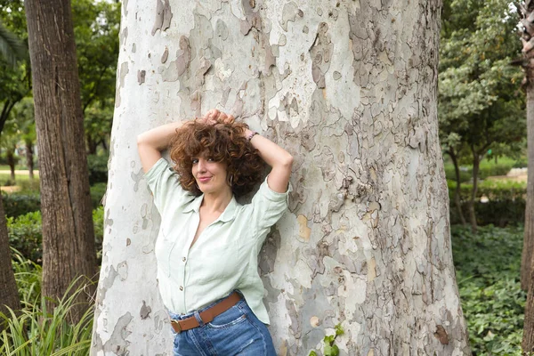 Portrait Attractive Mature Woman Curly Brown Hair Shirt Leaning Tree — Foto Stock