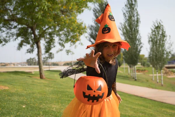 Girl Black Shirt Witch Hat Orange Skirt Pumpkin Arm Hand — стоковое фото