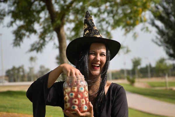 Woman Black Witch Suit Hat One Hand Jar Full Eyes — 스톡 사진