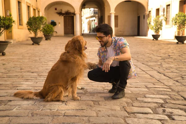 Young Hispanic Man Beard Sunglasses Holding His Dog Paw Very — стоковое фото