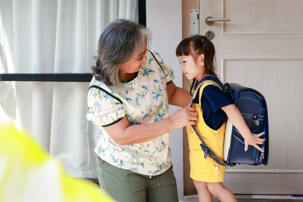 老祖母和可爱的小孙女一起住在家里 奶奶早上给孙女穿上上学的衣服 幼稚园儿童教育概念 — 图库照片