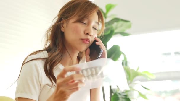 Beautiful Asian Woman Sick Flu Stay Home Holding Black Smartphone — Stock video