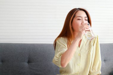 Grip olmuş Asyalı bir kadın. Evde kalıyor. Ağrı kesici al ve sade su iç. sağlık hizmeti kavramı