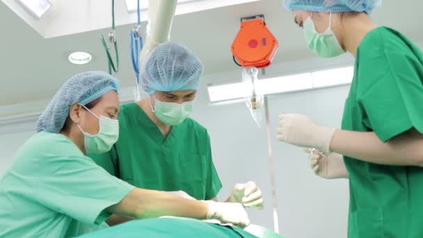 아시아의 의사들로 이루어진 수술실의 침대에 환자에게 수술을 의학적 — 비디오