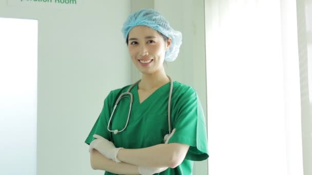 手術室の前に立つアジア系の女性外科医患者に手術を成功させた後は親指を立てて微笑む 病院の医療概念 美容整形 — ストック動画