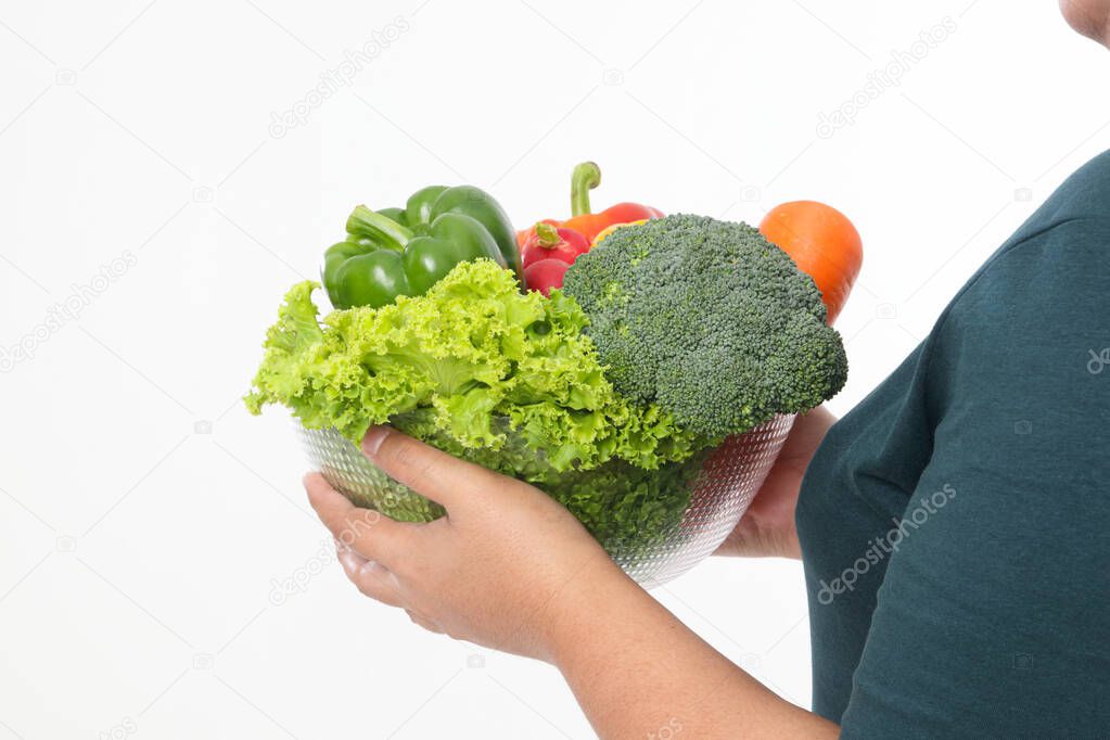 Fat woman holding a cup filled with various kinds of organic vegetables. Eat to lose weight. health care concept, eat healthy food. white background