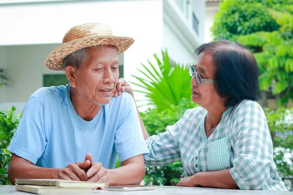 Asian elderly couple living at home taking care of each other happy with life .The concept of the elderly in retirement age. senior health care