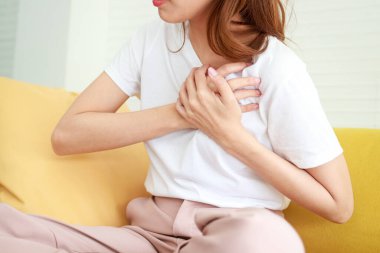 Asian women have chest pain. Heart palpitations are at risk of heart disease. Coronary artery disease. Hospital concept and health care