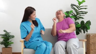 Female doctor and elderly female patient The two were happy dancing together. Concept of medical services in hospitals. physical therapy center rejuvenate the elderly