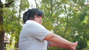 Fat Asian women exercise to lose weight in the morning. Sports concepts, health care. weight loss