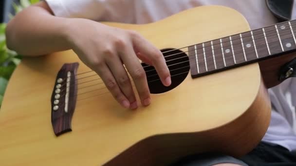 Asian Boys Practice Playing Acoustic Guitar Garden Home Music Learning — Stock Video