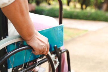 an elderly person sitting on a wheelchair Making it possible to travel to various places easily. The concept of health care for the elderly, devices that help disabled people become more self-reliant.
