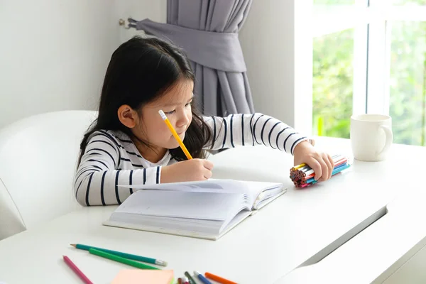 Asian little girl Study at home. Concept of primary education. Learn online from home