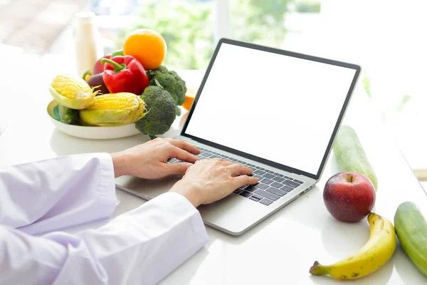 Asian female doctor or nutritionist Use a laptop for online video calls. Give advice to the patient about food. online patient health care concept Healthy eating. Weight loss. white screen.