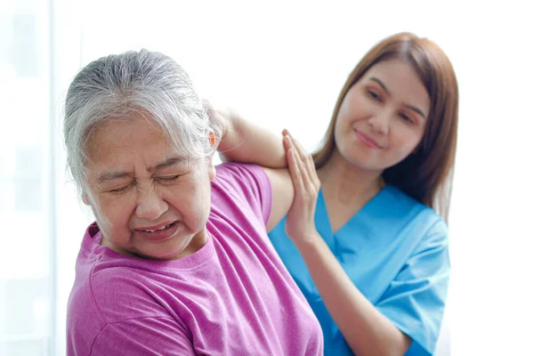 physiotherapist, medical specialist Stimulates recovery of the body for the elderly. Concept of physical rehabilitation for the elderly. Elderly Health and Physical Therapy Center