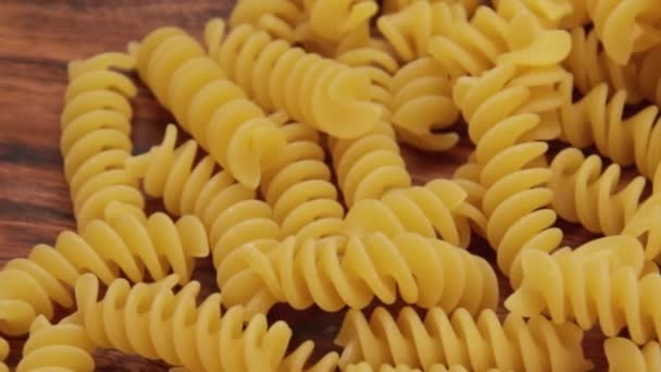 Pile Raw Fusilli Wooden Background — Stock Video