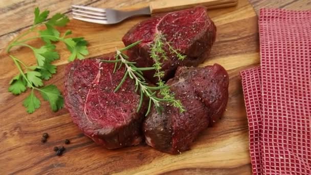 Raw Beef Steak Rosemary Thyme Wooden Board — Stock Video