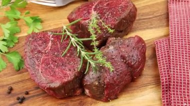 Biberiyeli çiğ biftek ve ahşap tahtada kekik.
