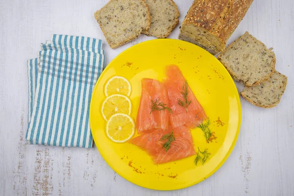 Sarı tabakta füme somon tostu.