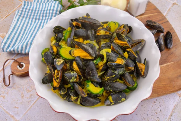 delicious cooked mussels with zucchini in white plate