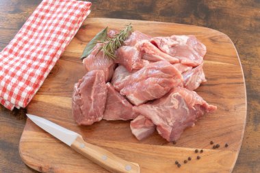 Tahtada izole edilmiş çiğ domuz eti parçaları.