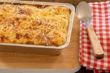 Tahta bir tabakta pişmiş lazanya manzarası.