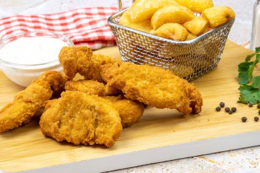 Kızarmış tavuk ve patates kızartması.