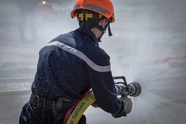 person holding a fire hose during a drill