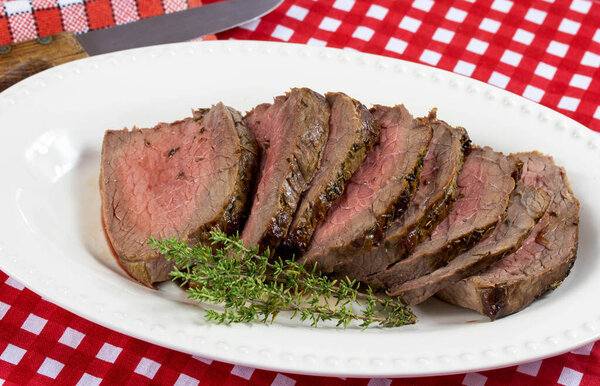 Slice of cooked roast beef in a dish