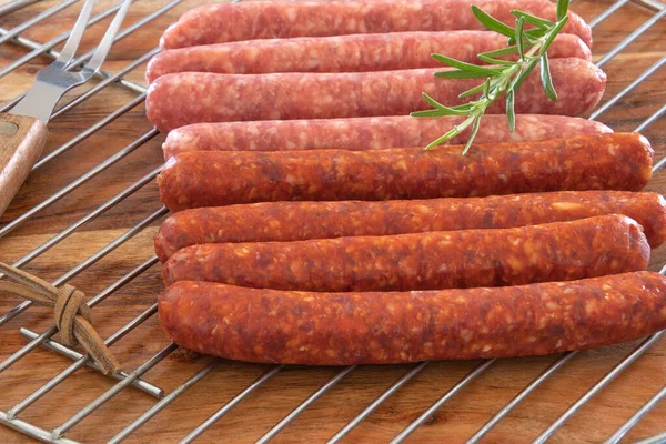 Izgarada çiğ merguez sosislerini yakın.